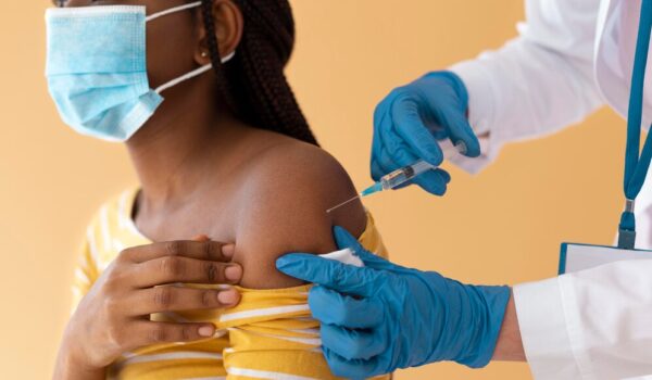 close-up-young-woman-getting-vaccinated_23-2148989404